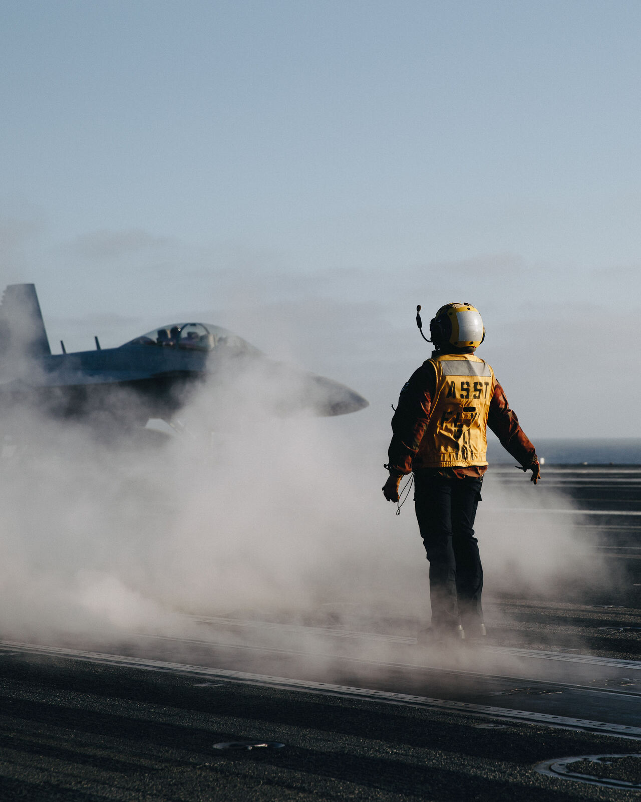 Flight-deck crew in catapult steam