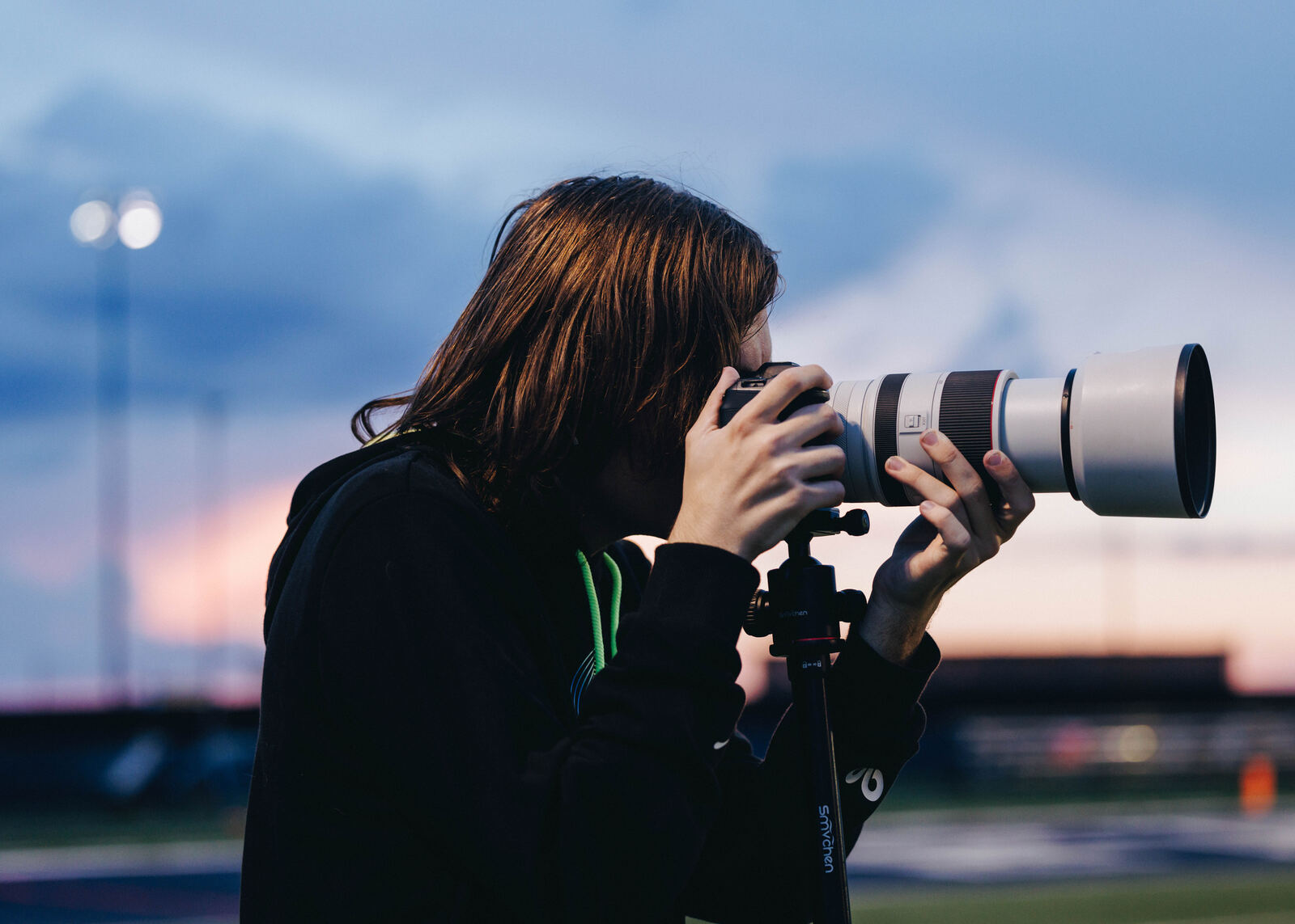 A student with a long lens at sunset