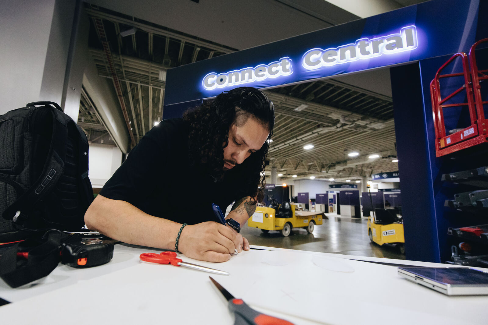 Worker drawing plans at a table